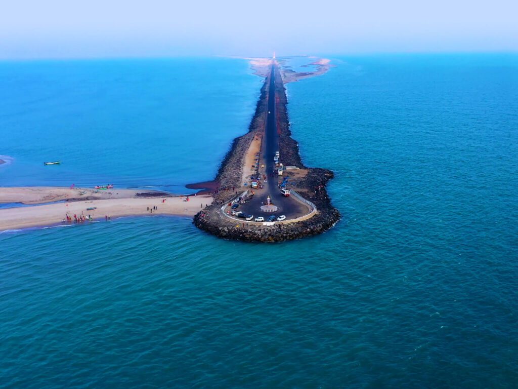 A view of the clear blue waters and white sands of Dhanushkodi Beach, a destination near Daiwik Hotels Rameswaram.